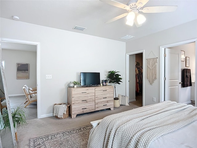 bedroom with carpet floors, baseboards, ceiling fan, a spacious closet, and a closet