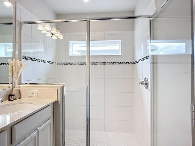 bathroom featuring a stall shower and vanity