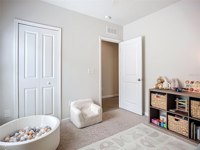 bedroom featuring carpet, baseboards, and a closet