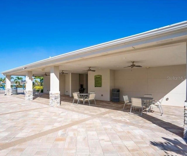 view of patio / terrace featuring a ceiling fan, outdoor dining area, and fence