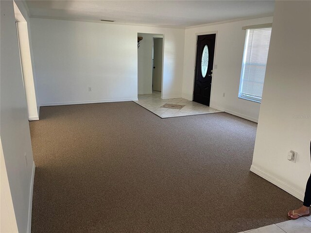 236 Davis Blvd, Sarasota, FL 34237 - foyer with light colored carpet, baseboards, and crown molding