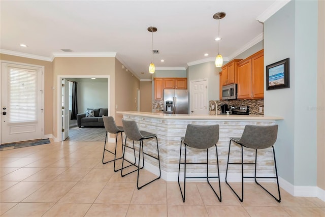 11455 52nd Ct E, Parrish, FL 34219 - kitchen featuring stainless steel appliances, a peninsula, a breakfast bar area, tasteful backsplash, and light tile patterned flooring