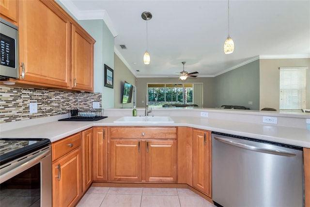 11455 52nd Ct E, Parrish, FL 34219 - kitchen featuring stainless steel appliances, a sink, crown molding, light countertops, and light tile patterned floors