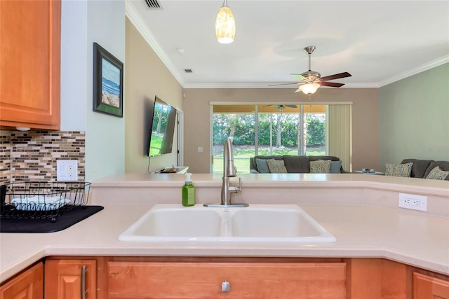 11455 52nd Ct E, Parrish, FL 34219 - kitchen featuring a sink, open floor plan, ceiling fan, light countertops, and ornamental molding