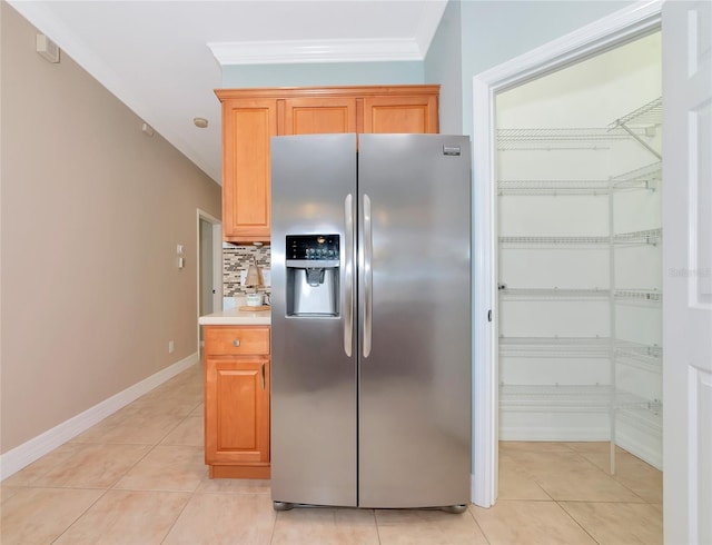 11455 52nd Ct E, Parrish, FL 34219 - kitchen with stainless steel fridge with ice dispenser, crown molding, light tile patterned floors, decorative backsplash, and baseboards