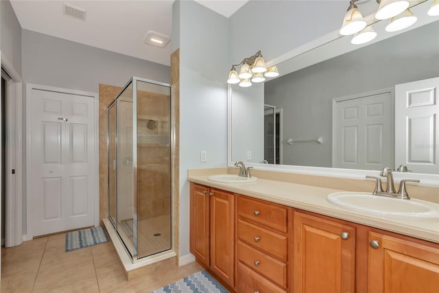 11455 52nd Ct E, Parrish, FL 34219 - bathroom with tile patterned floors, a shower stall, and double vanity