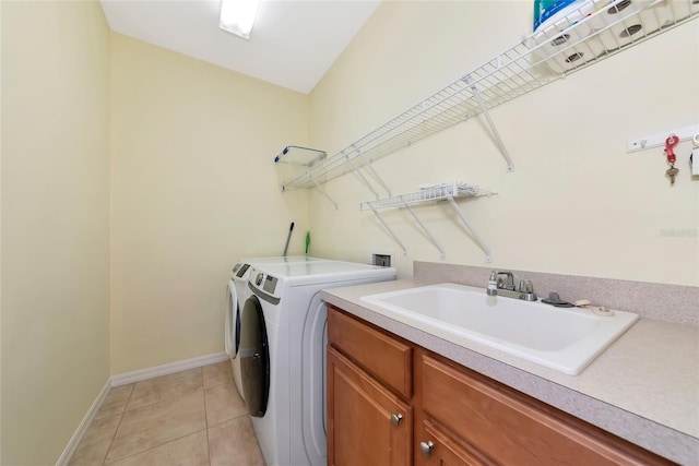 11455 52nd Ct E, Parrish, FL 34219 - clothes washing area featuring washing machine and clothes dryer, cabinet space, baseboards, and light tile patterned floors