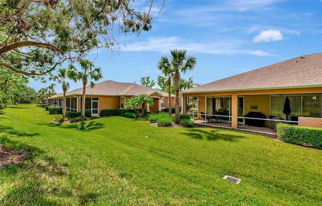 11455 52nd Ct E, Parrish, FL 34219 - back of property with a lawn and stucco siding