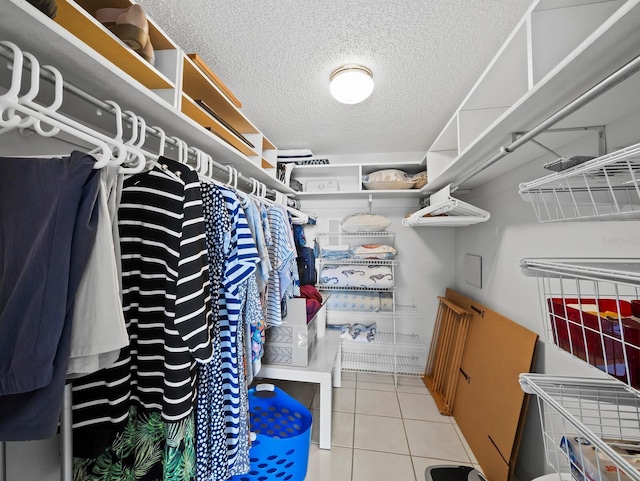 spacious closet with light tile patterned floors