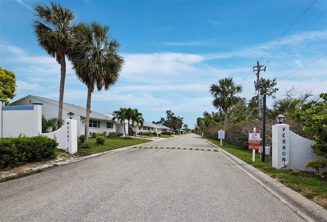view of asphalt road with street lighting