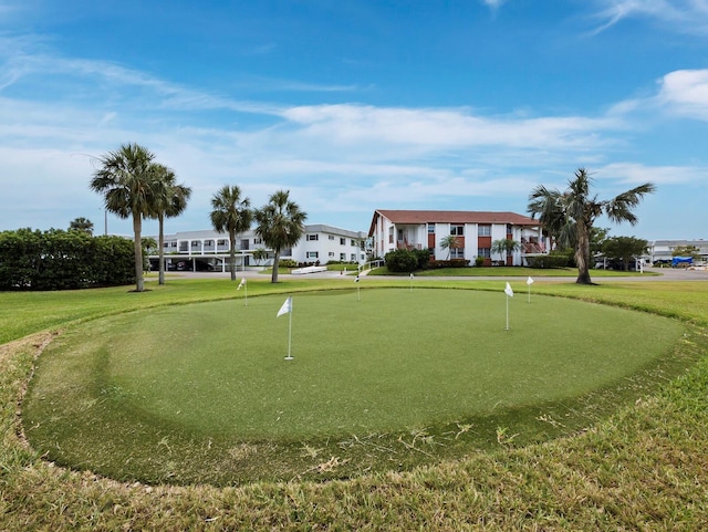 surrounding community with a putting green and a lawn