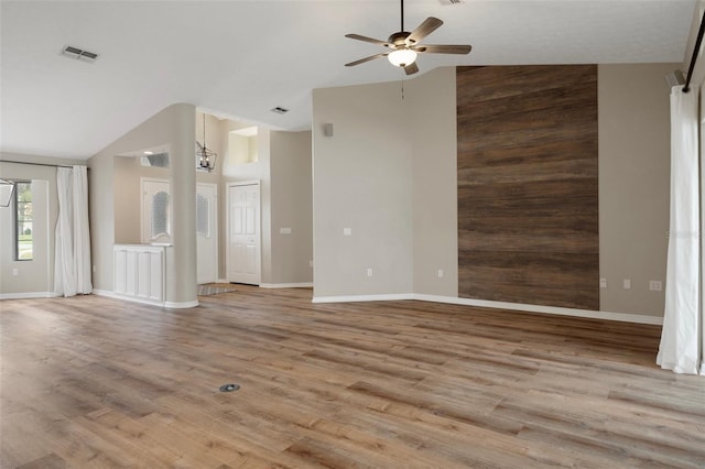 unfurnished living room with a ceiling fan, wood finished floors, high vaulted ceiling, and baseboards