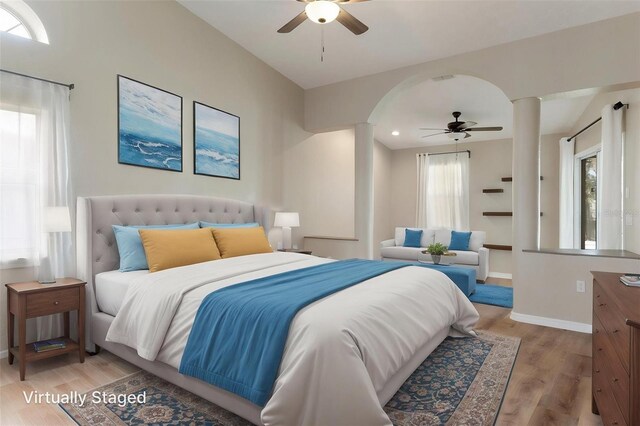 bedroom with light wood-type flooring, baseboards, arched walkways, a ceiling fan, and recessed lighting