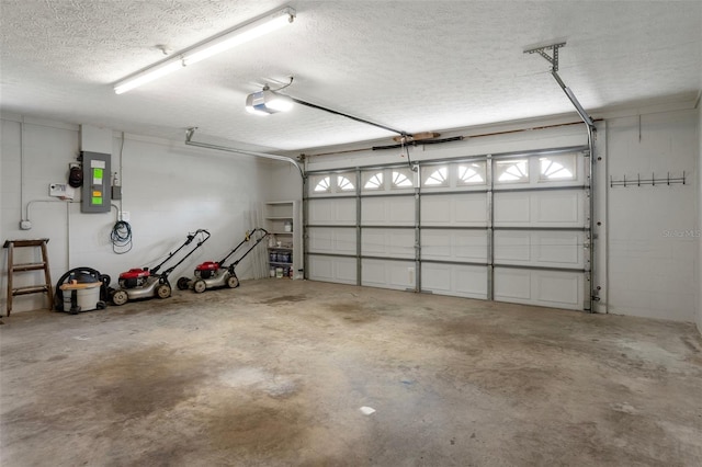 garage with electric panel and a garage door opener