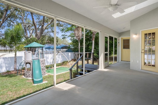 unfurnished sunroom featuring a ceiling fan and lofted ceiling