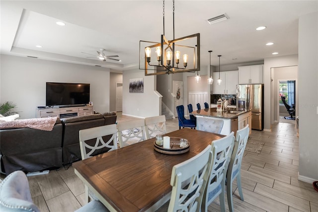 dining space featuring ceiling fan, recessed lighting, stairway, a chandelier, and baseboards