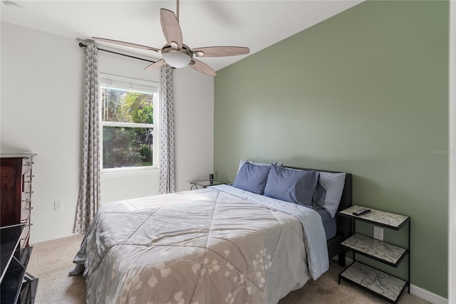 carpeted bedroom featuring a ceiling fan and vaulted ceiling