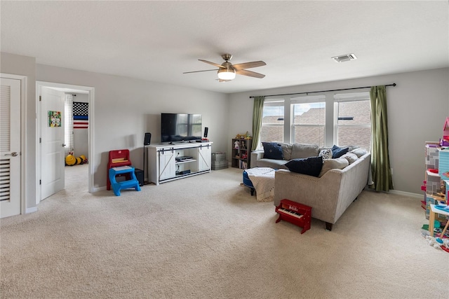 living room with a ceiling fan and light colored carpet