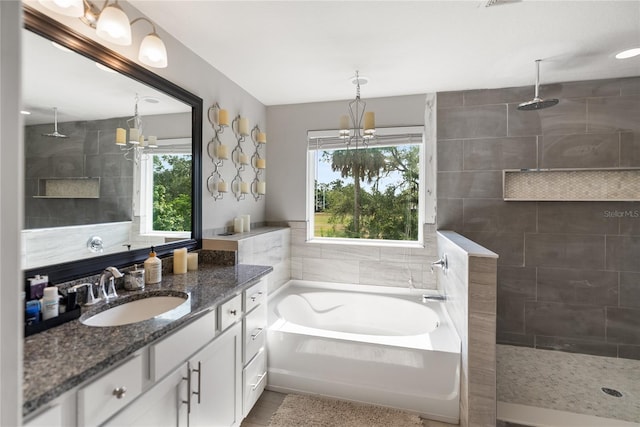 full bathroom featuring a chandelier, plenty of natural light, and walk in shower