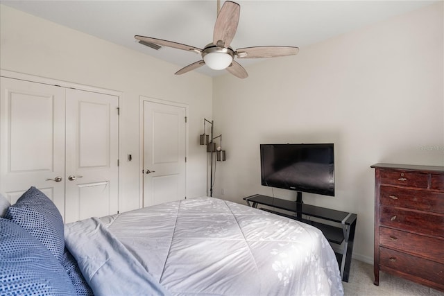 carpeted bedroom featuring a closet and ceiling fan