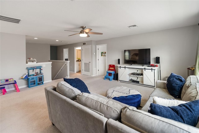 living area featuring light colored carpet, a ceiling fan, baseboards, and recessed lighting