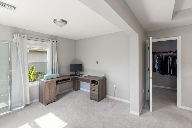 home office with light carpet and baseboards