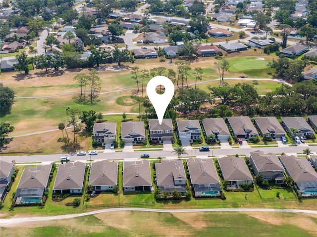 aerial overview of property's location featuring nearby suburban area and a golf course