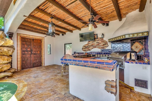 view of patio featuring a ceiling fan and exterior kitchen