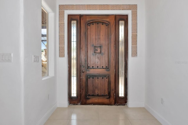 tiled entrance foyer featuring baseboards