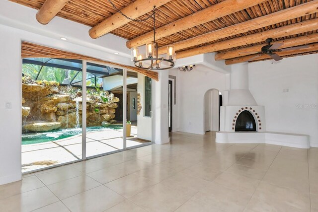 unfurnished living room with wood ceiling, beam ceiling, a chandelier, tile patterned floors, and ceiling fan