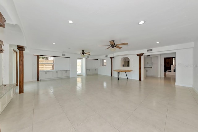 unfurnished living room with decorative columns, recessed lighting, ceiling fan, and light tile patterned floors