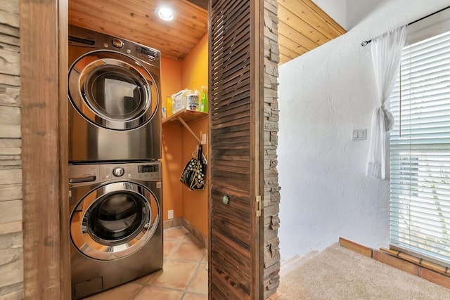 clothes washing area with estacked washer and dryer, recessed lighting, tile patterned flooring, and wood ceiling
