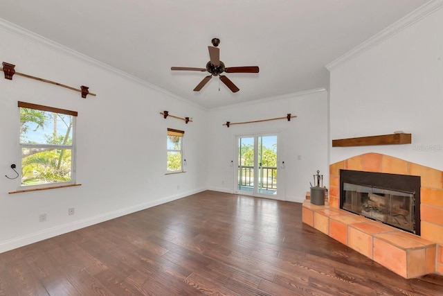 unfurnished living room with a tiled fireplace, wood finished floors, crown molding, ceiling fan, and baseboards