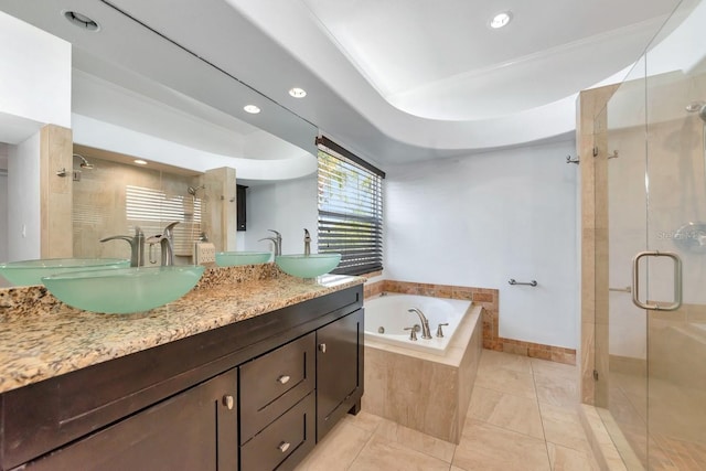 bathroom with a stall shower, a jetted tub, tile patterned flooring, double vanity, and recessed lighting