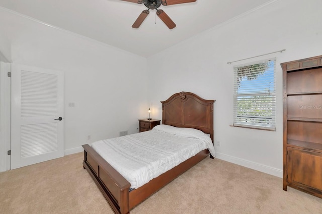 bedroom with light carpet, baseboards, and a ceiling fan