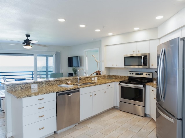 2400 N Beach Rd Unit 1, Englewood, FL 34223 - kitchen featuring appliances with stainless steel finishes, a sink, a peninsula, white cabinets, and recessed lighting