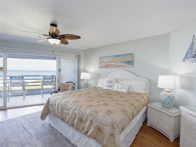 2400 N Beach Rd Unit 1, Englewood, FL 34223 - bedroom featuring access to outside, wood finished floors, a ceiling fan, and a water view