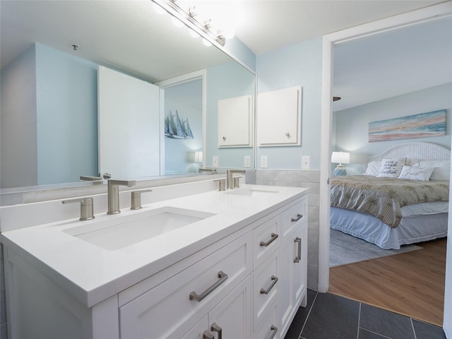 2400 N Beach Rd Unit 1, Englewood, FL 34223 - bathroom featuring tile patterned floors, ensuite bathroom, double vanity, and tile walls