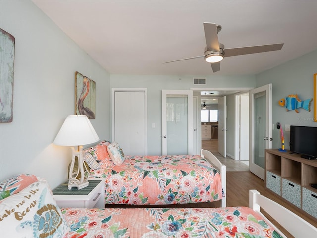 2400 N Beach Rd Unit 1, Englewood, FL 34223 - bedroom featuring multiple closets, wood finished floors, and a ceiling fan