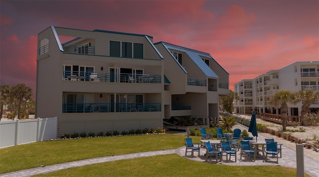 2400 N Beach Rd Unit 1, Englewood, FL 34223 - back of property at dusk featuring a patio area