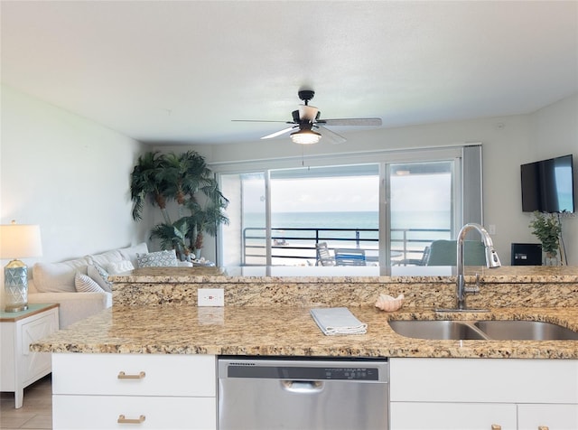 2400 N Beach Rd Unit 1, Englewood, FL 34223 - kitchen with dishwasher, a sink, a ceiling fan, light stone countertops, and white cabinetry