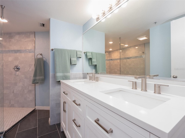 2400 N Beach Rd Unit 1, Englewood, FL 34223 - full bath featuring a walk in shower, tile patterned flooring, double vanity, and recessed lighting