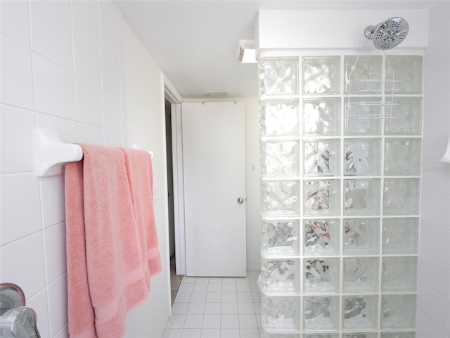 2400 N Beach Rd Unit 1, Englewood, FL 34223 - full bathroom with a walk in shower, tile patterned flooring, and tile walls