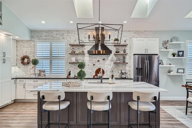 11367 Perico Isle Cir, Bradenton, FL 34209 - kitchen with stainless steel refrigerator with ice dispenser, open shelves, a skylight, backsplash, and recessed lighting