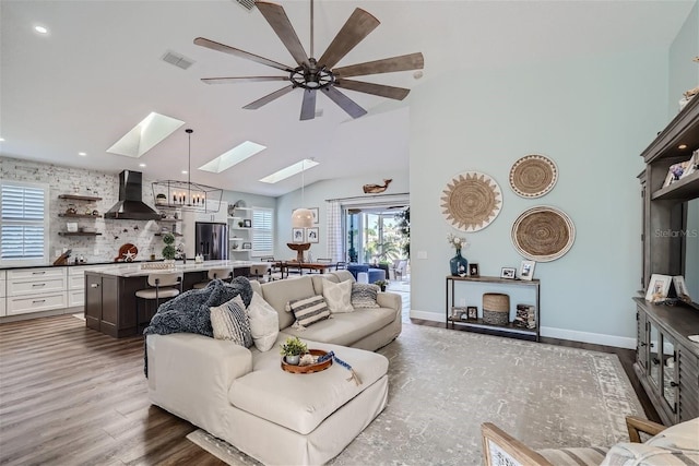 11367 Perico Isle Cir, Bradenton, FL 34209 - living room featuring a skylight, dark wood-type flooring, a ceiling fan, recessed lighting, and a chandelier
