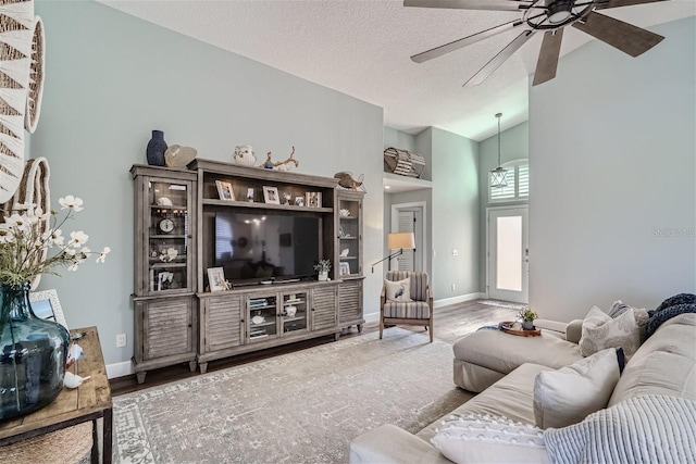 11367 Perico Isle Cir, Bradenton, FL 34209 - living room featuring a ceiling fan, wood finished floors, baseboards, high vaulted ceiling, and a textured ceiling