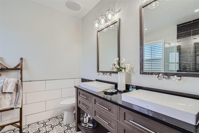 11367 Perico Isle Cir, Bradenton, FL 34209 - full bathroom with tile walls, toilet, tile patterned flooring, double vanity, and an enclosed shower