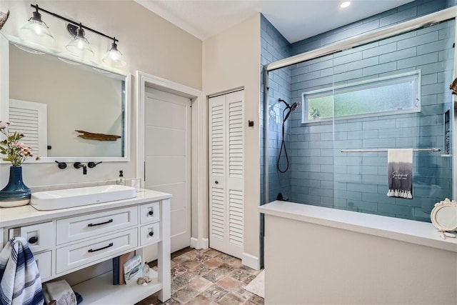 11367 Perico Isle Cir, Bradenton, FL 34209 - full bath featuring a closet, tiled shower, vanity, stone finish flooring, and baseboards