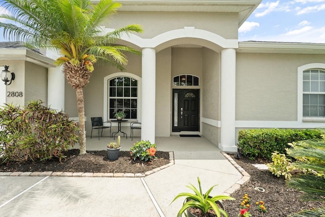 2808 124th Ave E, Parrish, FL 34219 - view of exterior entry featuring a porch and stucco siding