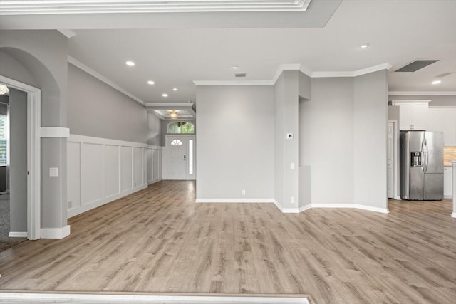 2808 124th Ave E, Parrish, FL 34219 - unfurnished living room featuring ornamental molding, light wood finished floors, recessed lighting, and wainscoting